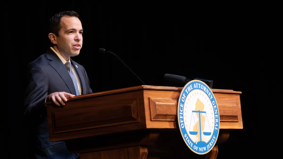 New Jersey Attorney General Matthew Platkin speaks at a lectern.