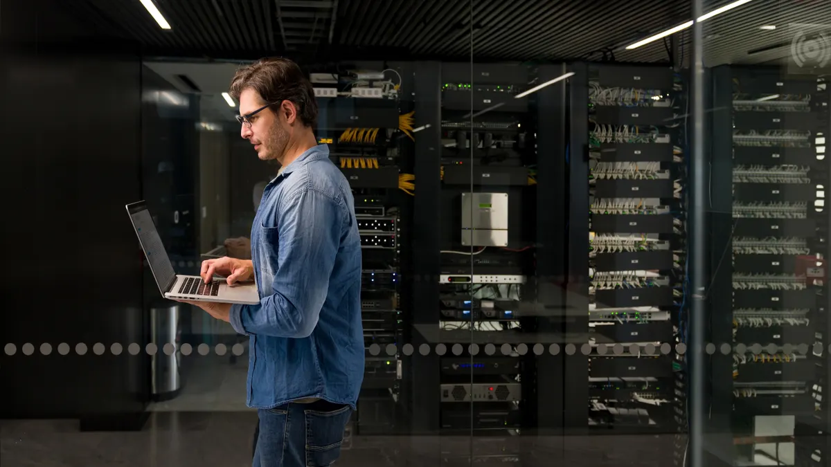 IT technician fixing a problem on a network server at an office building