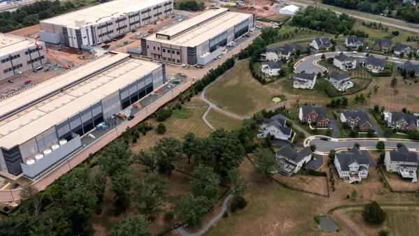An aerial view of large industrial buildings near homes.