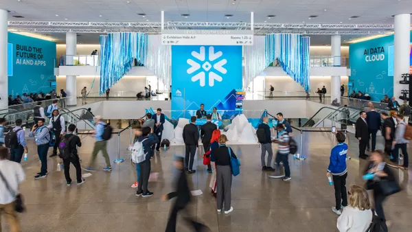 Attendees at the Snowflake Summit 2025 conference walk through a lobby of the Marcone Center in San Francisco on June 3, 2025.
