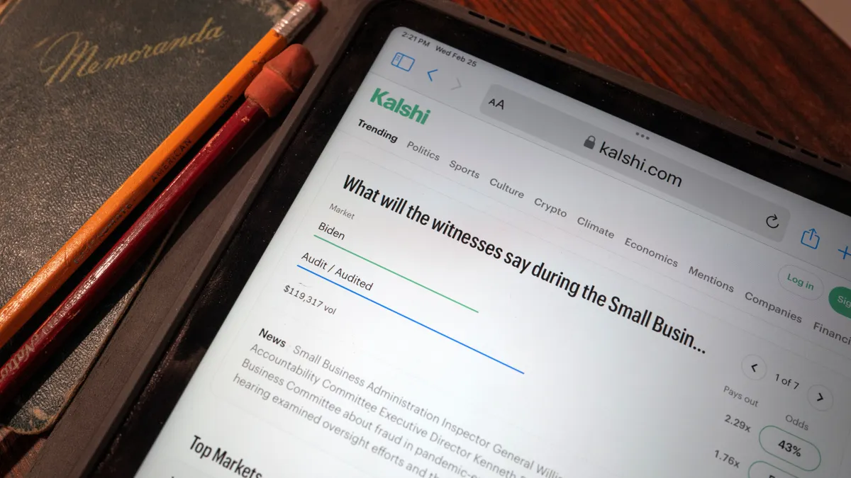 A tablet displays the Kalshi prediction-markets app.
