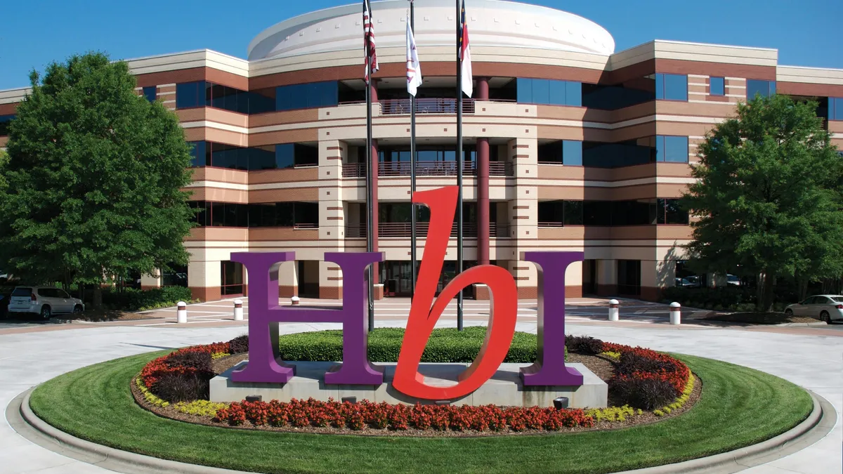 Corporate headquarters of HanesBrands as seen from outside with HBI signage in the front.