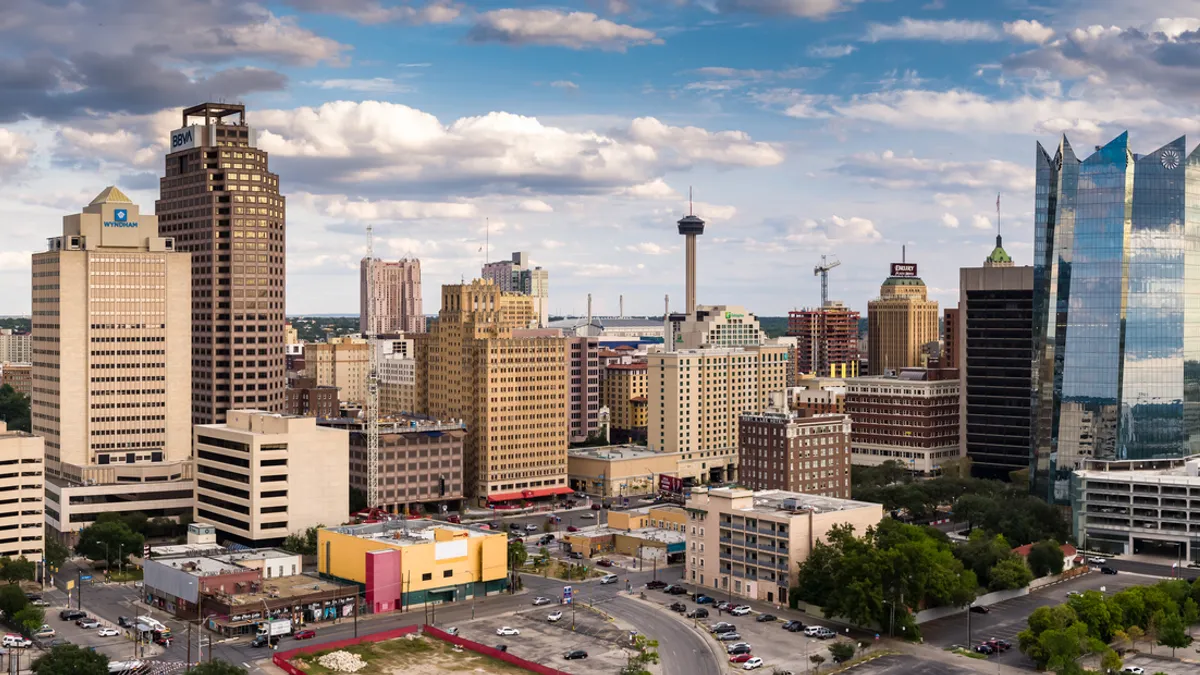 A sunny San Antonio, Texas skyline with several very tall buildings in frame.