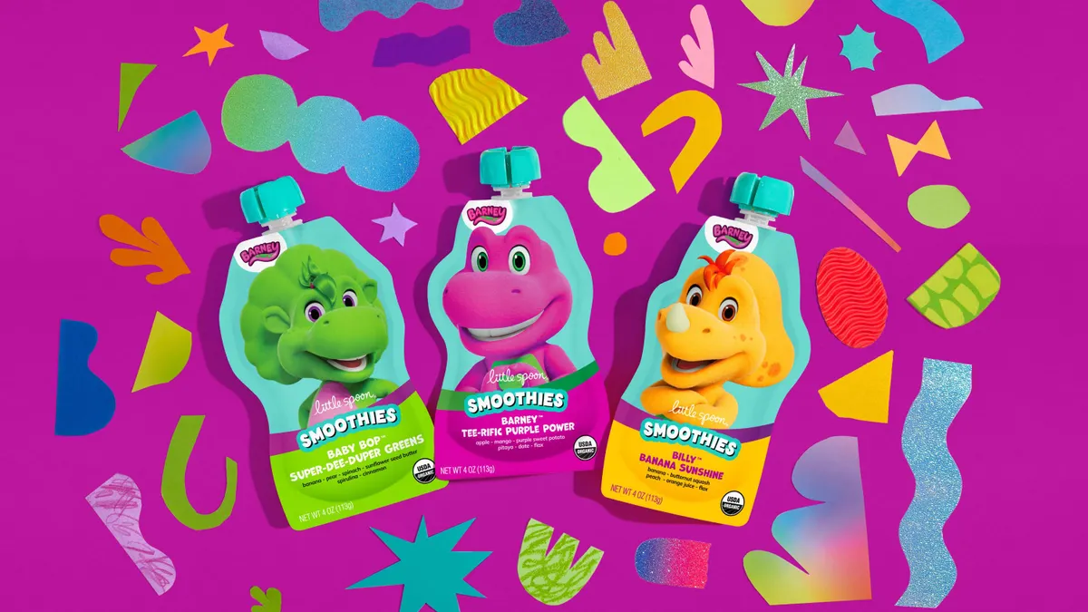 Three Barney-inspired smoothie packets depicting Barney, Baby Bop and Billy are displayed against a purple background.