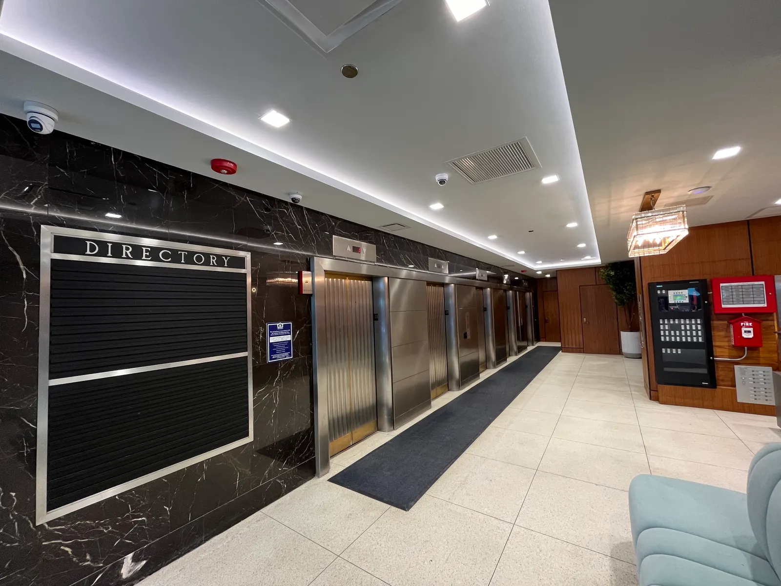 An interior lobby with several closed elevator doors.