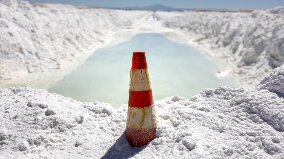 Lithium-rich brine dries in an evaporation pond next to mounds of salt bi-product at a lithium mine in the Atacama Desert on August 24, 2022 in Salar de Atacama, Chile.