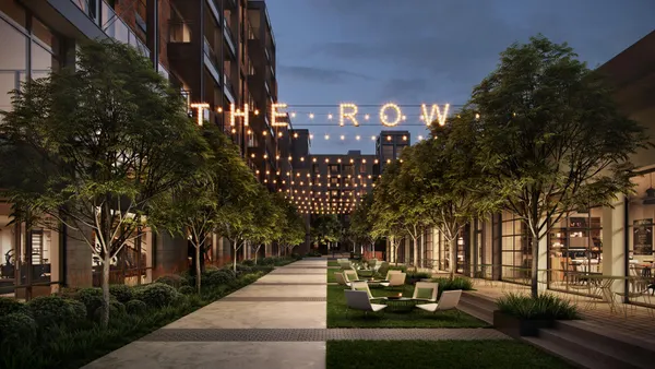 Courtyard with trees and and chairs between apartment buildings.
