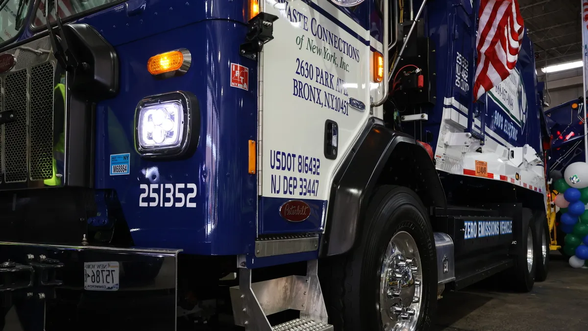 Close up of the front of a Waste Connections electric refuse truck