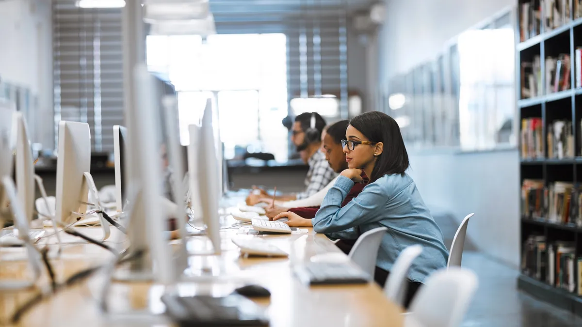 Woman using a computer in a college classroom