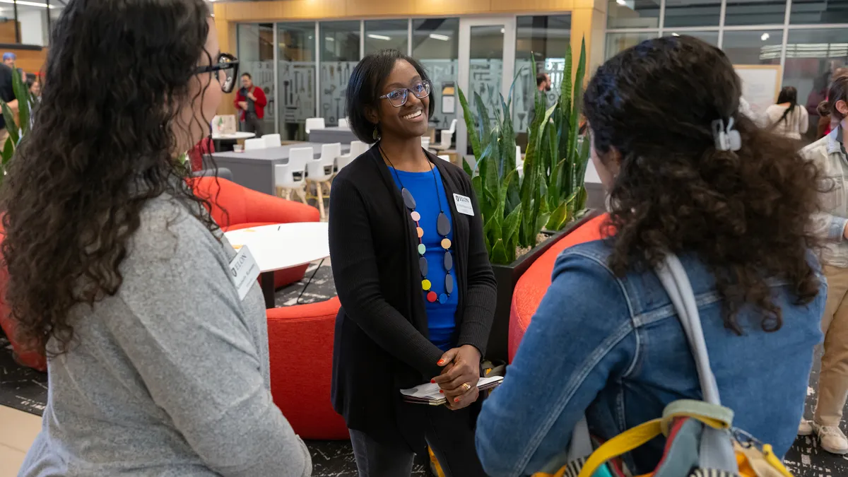 Sirena Hargrove-Leak talking to two female colleagues.