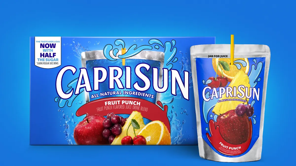 A box of Fruit Punch Capri Sun on a blue background with a juice pouch in the foreground.