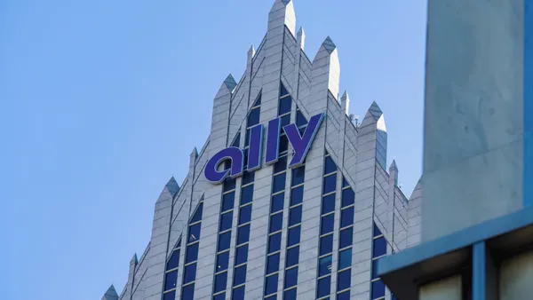 A skyscraper with the word "Ally" on it is shown, with blue sky behind.