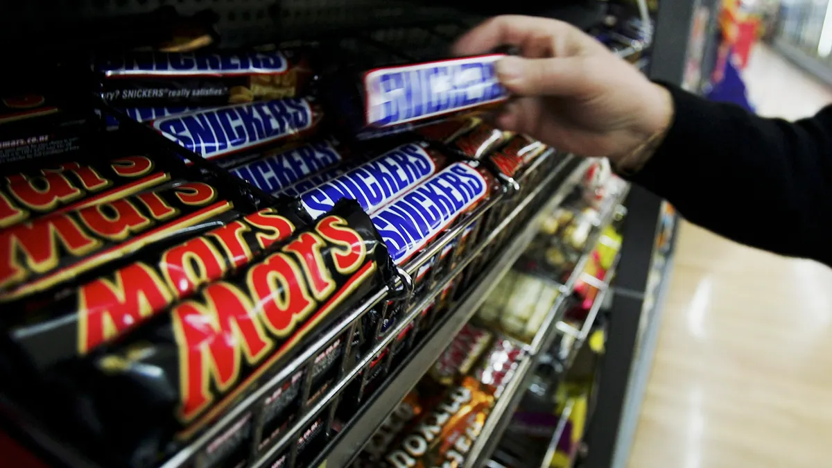 A customer picks up a Snickers Bar in a supermarket August 18, 2005 in Sydney, Australia.