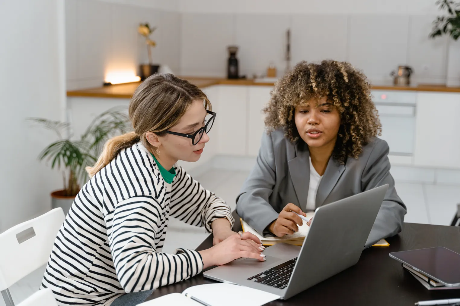 Two employees work together in an office