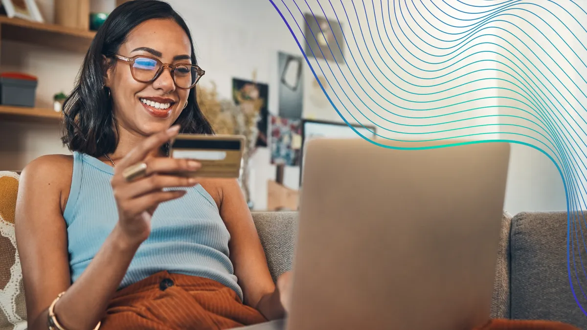 Woman on couch with laptop credit card and online shopping payment and ecommerce with fintech