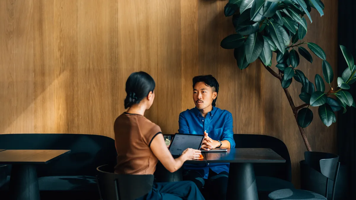 Colleagues Engaged in a Business Meeting at a Modern Cafe