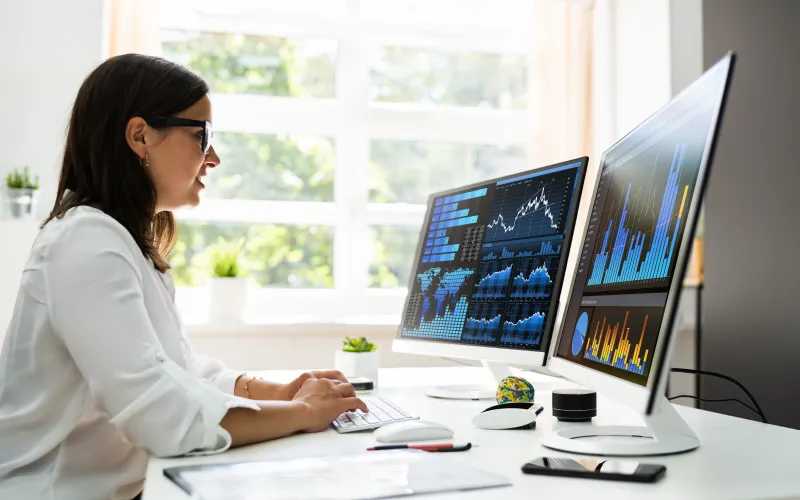 Women looking at dashboard analytics on screen.