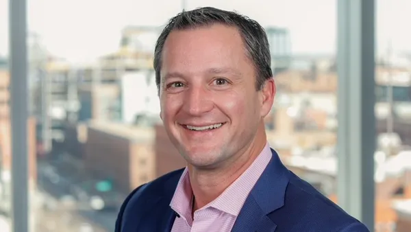 Professional photo of Paul Ziegler standing in front of a window.