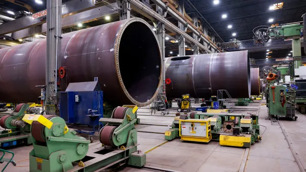 Massive metal tubes in a manufacturing facility.
