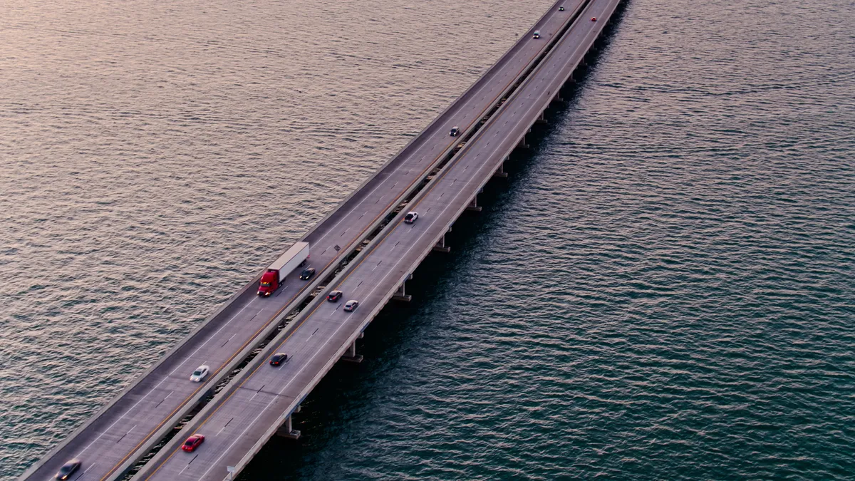 Drone shot of the Sunshine Skyway Bridge across lower Tampa Bay in Florida at sunrise.