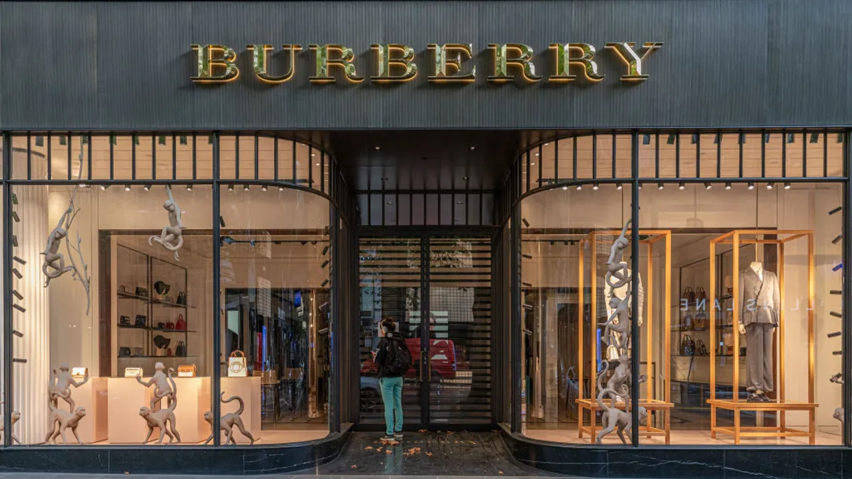 A woman looking inside a closed Burberry store on April 05, 2020 in Melbourne, Australia.