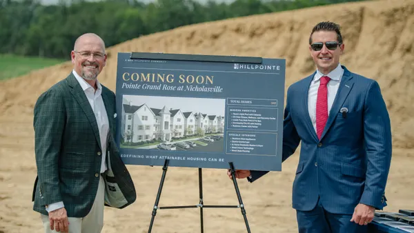 Sign with a rendering of the upcoming Pointe Grand Citation at Lexington development at the groundbreaking event.