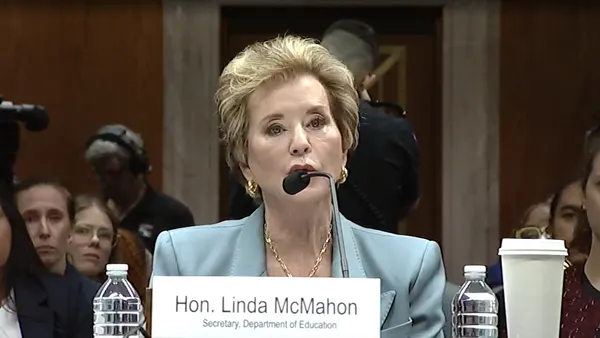 Linda McMahon speaks into a microphone.