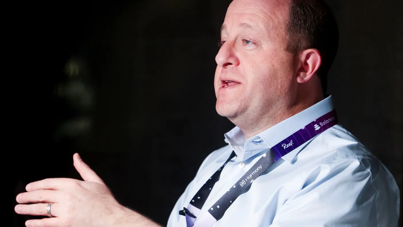 Colorado governor Jared Polis talks on a podcast.