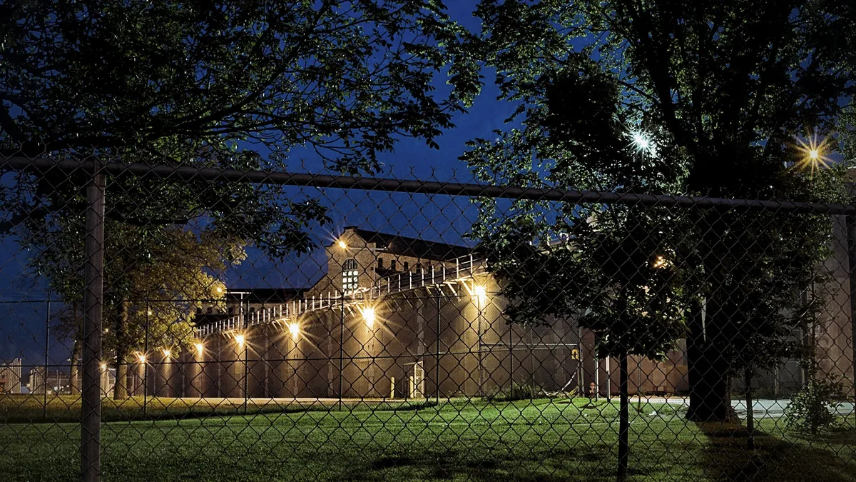 A prison courtyard at night.