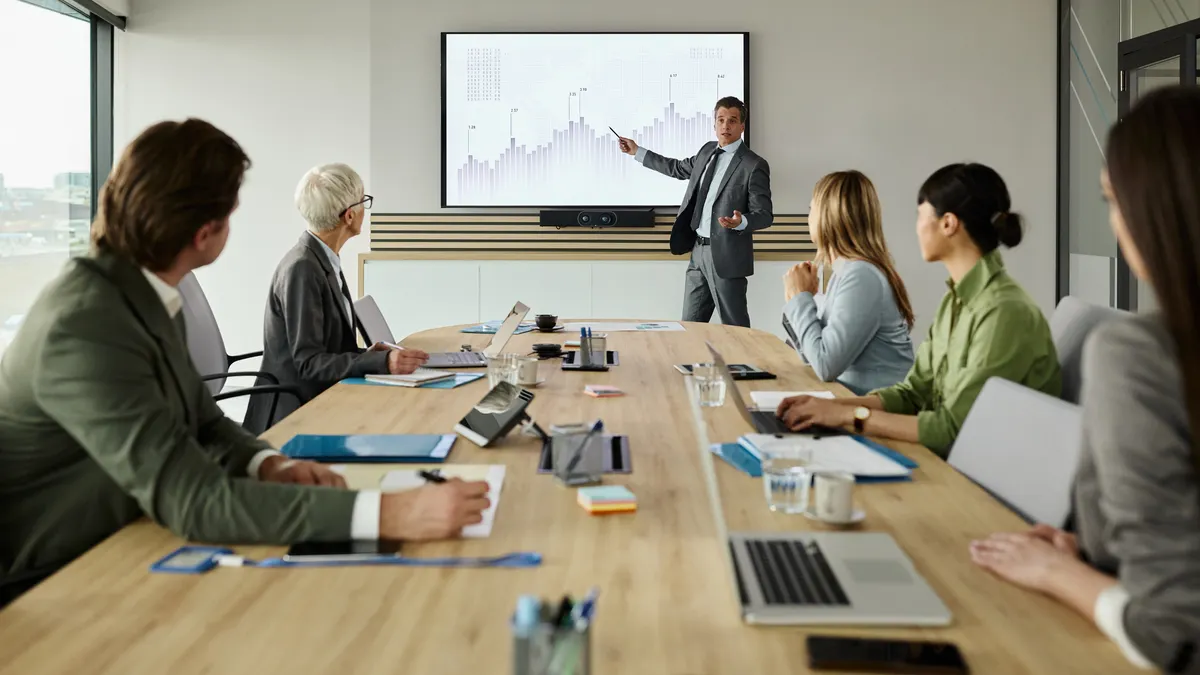 Manager giving a presentation to his colleagues in the office