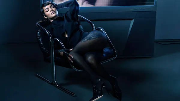 Teyana Taylor lounges in a black leather chair as part of a photograph for Revolve Magazine.