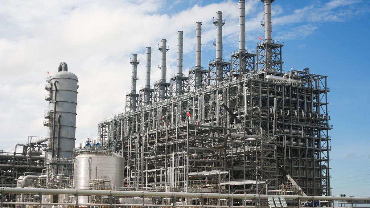 A chemical plant under a blue sky.