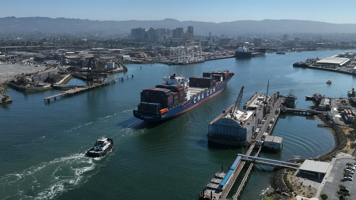 In an aerial view, a container ship is guided into the Port of Oakland on August 07, 2023 in Oakland, California.