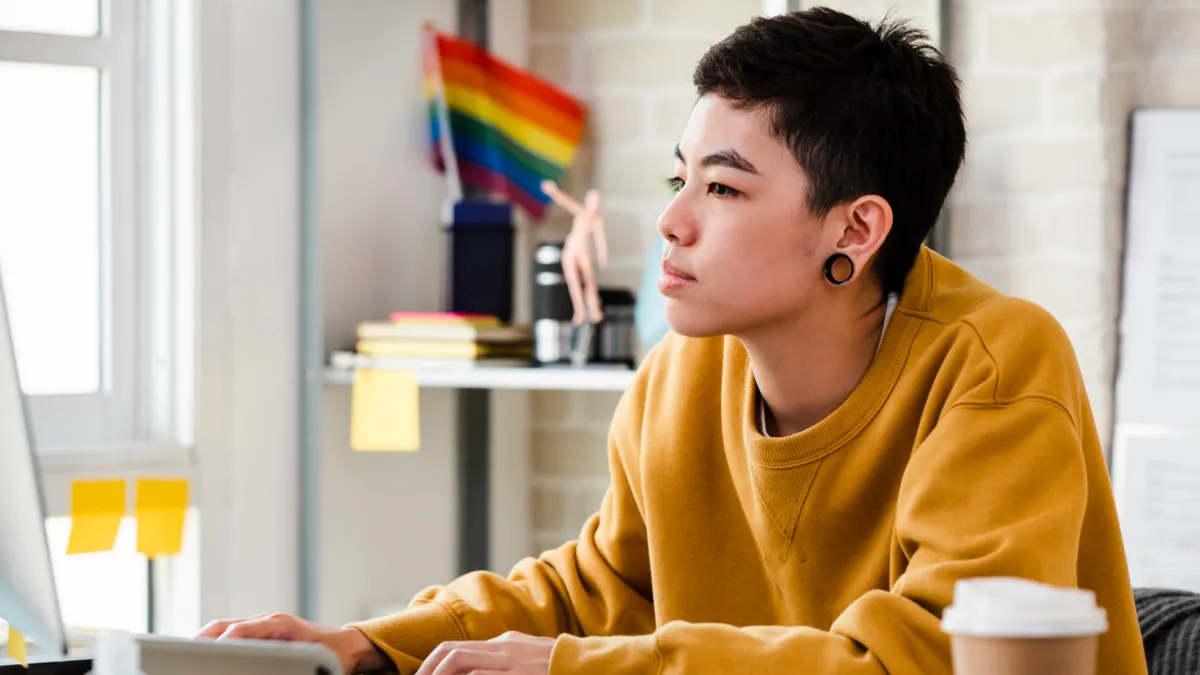 Young woman in casual attire working from home in living room