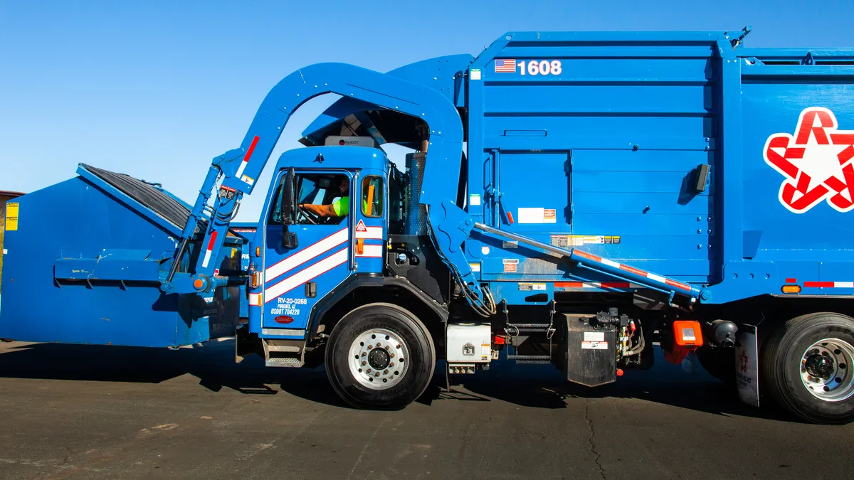 A Republic Services truck and dumpster.