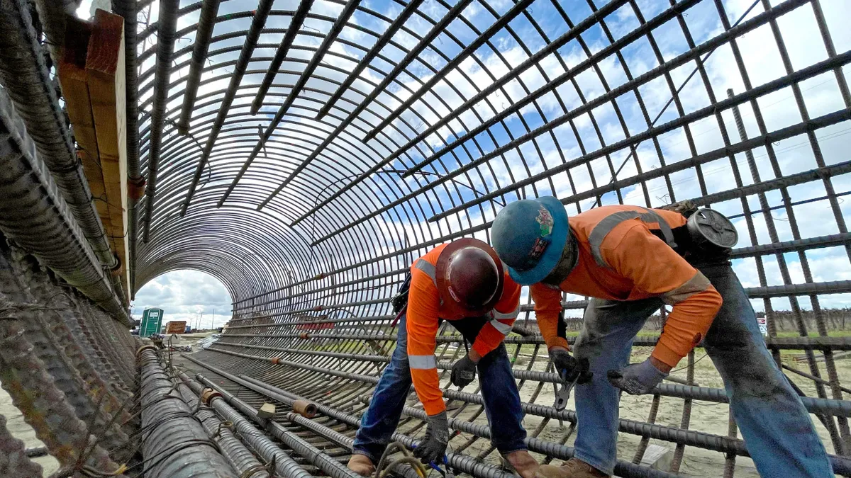 Workers tie rebar for the California high speed rail project