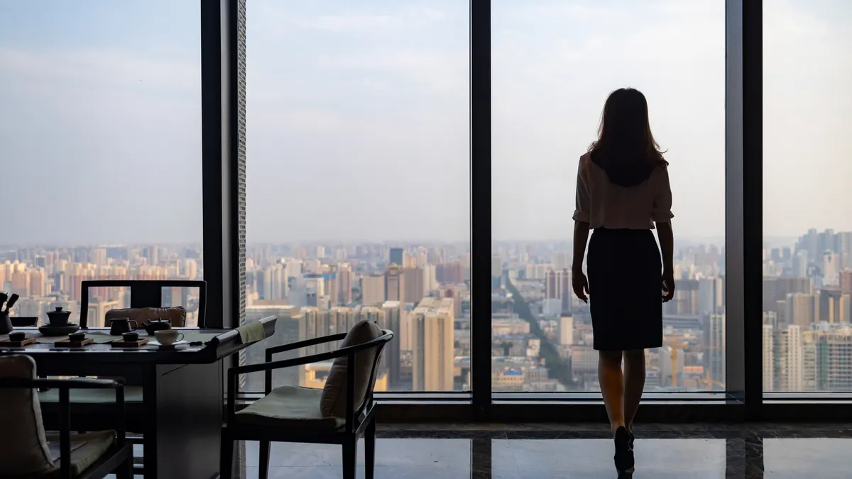 Business woman in front of glass windows