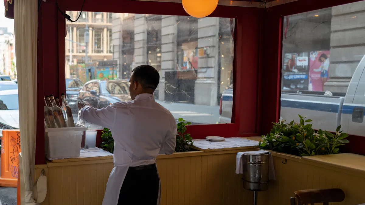 New York City waiter prepares dining room