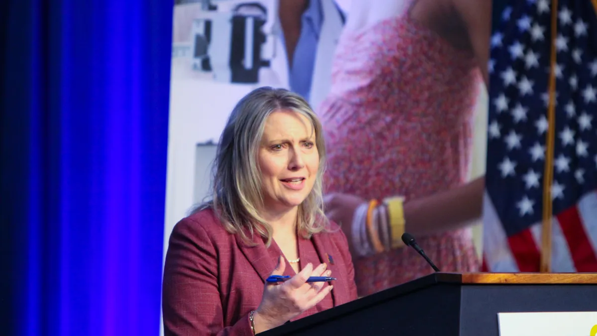 Jessica Looman is seen speaking at a podium.