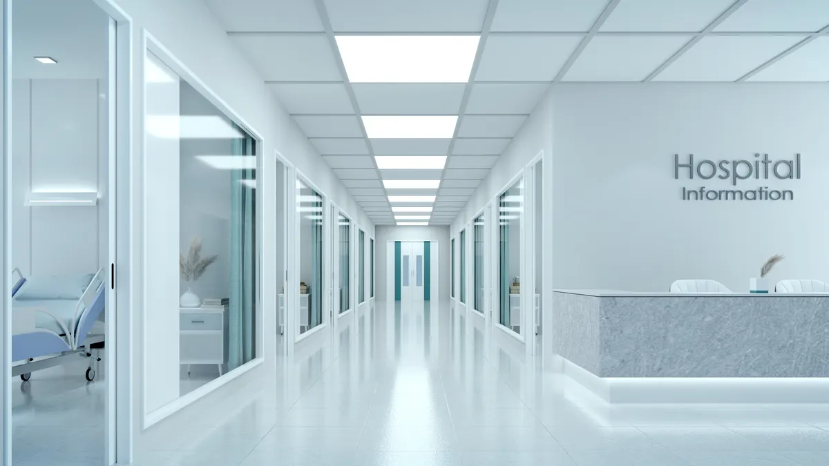 A rendering of an empty hospital corridor with a reception desk.