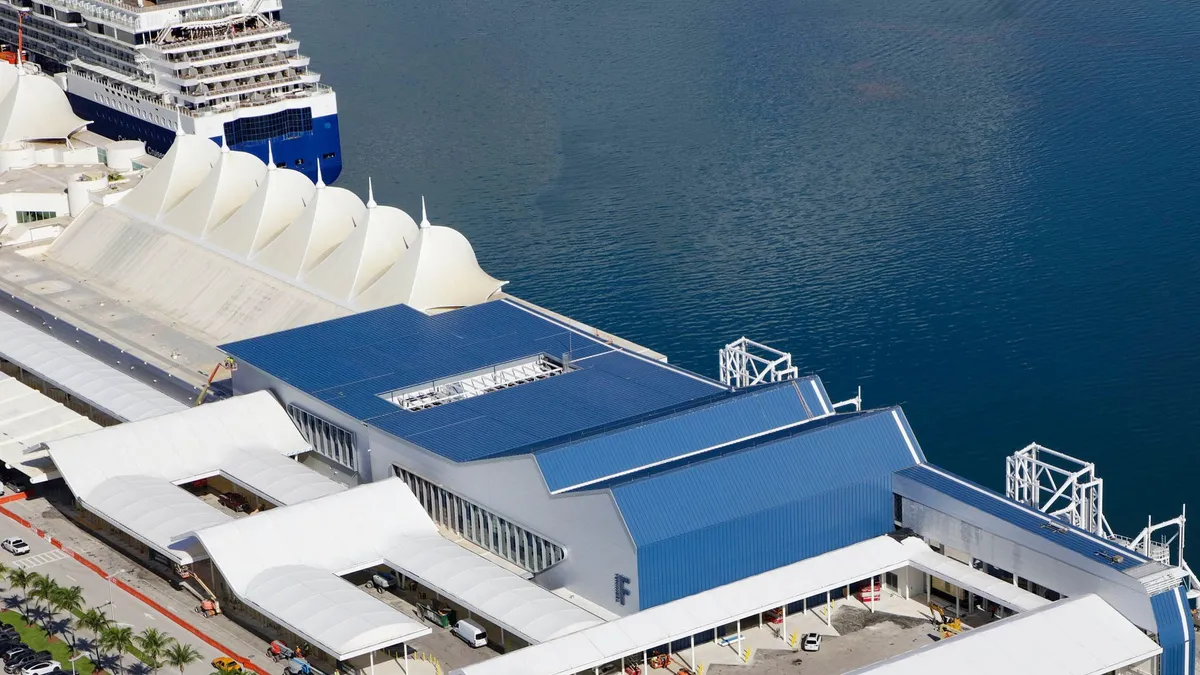 Cruise ship docked at a pier, ready to embark on a voyage