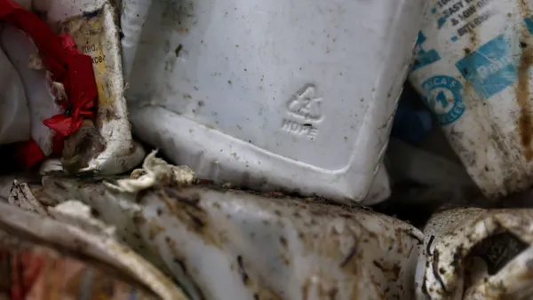 Closeup of a white plastic container in a bale of recycled plastic containers