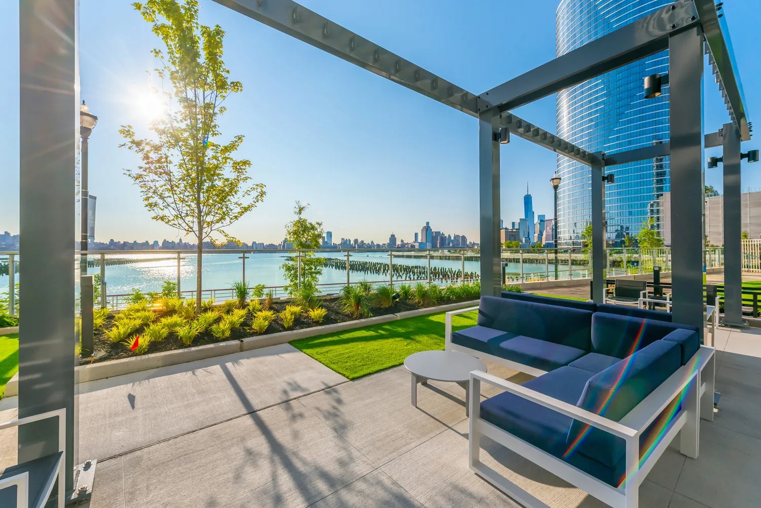 An outdoor waterfront lounge on an urban apartment property