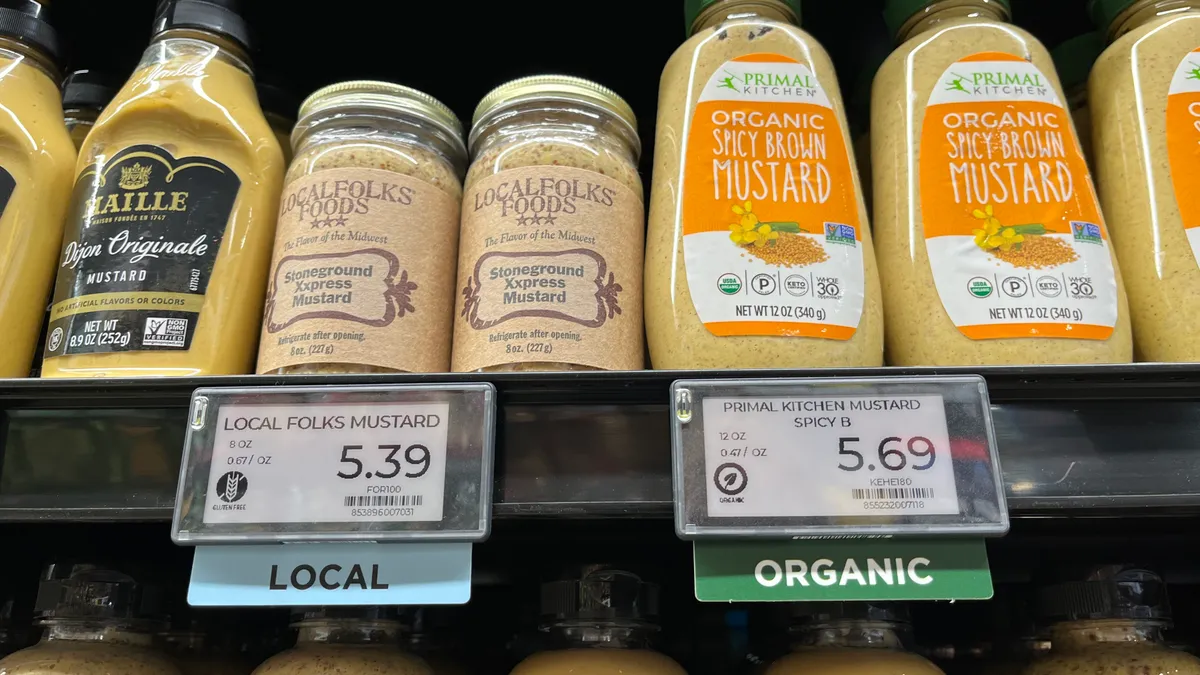 Closeup of grocery store items with "organic" and "local" shelf tags