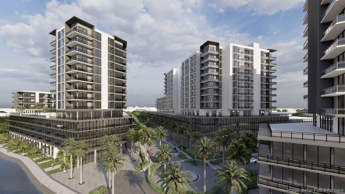 Grey and white high rise apartments with palm trees below.