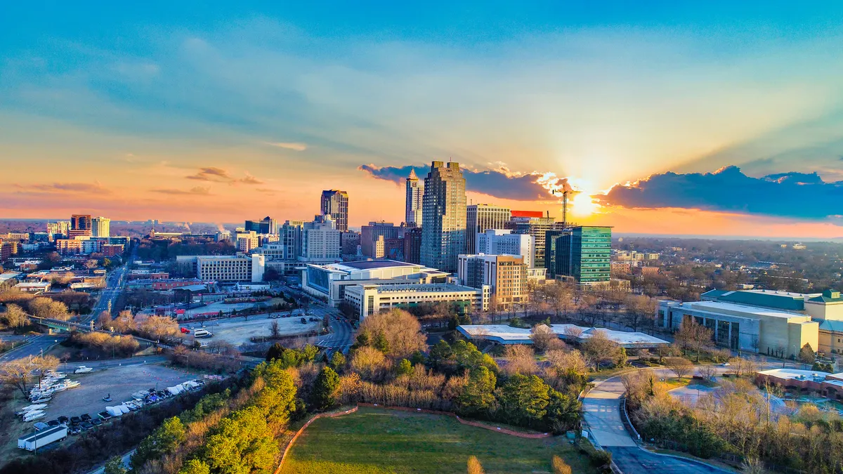 A city's skyline against the background of a pink sky.