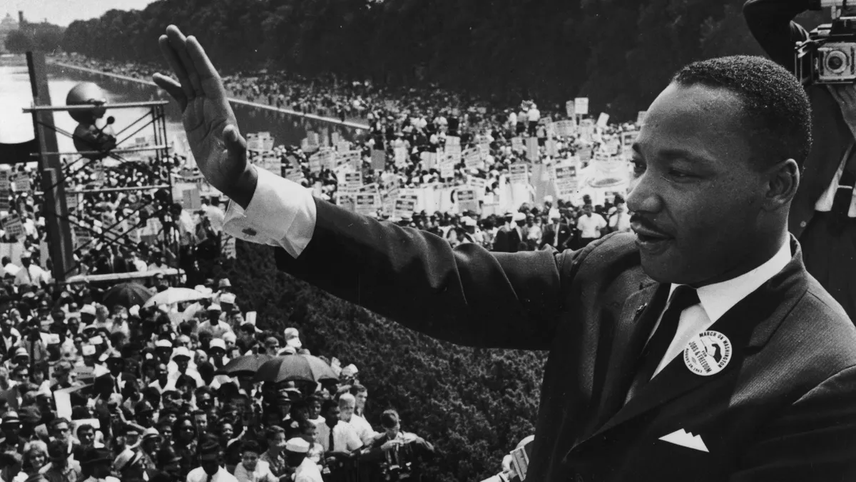 American civil rights leader Rev. Martin Luther King, Jr. waves to March on Washington for Jobs and Freedom participants during his "I have a dream" speech.