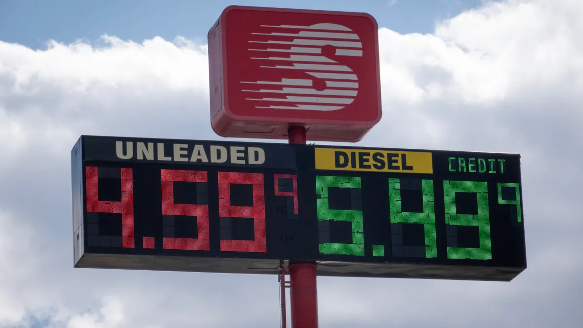 Sign on a high pole with prices for gasoline and diesel fuel.