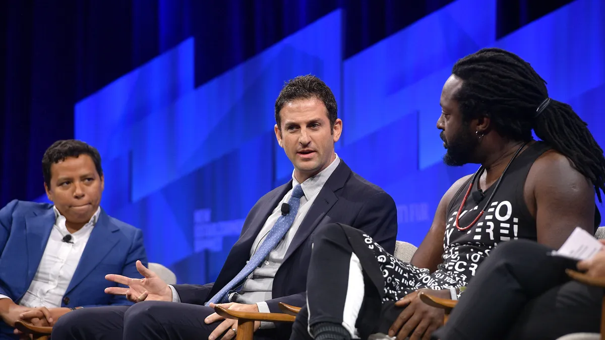 Editor-in-Chief of HuffPost Lydia Polgreen, Founder and CEO of Jigsaw Jared Cohen and author Marlon James seated in a conversation on stage.