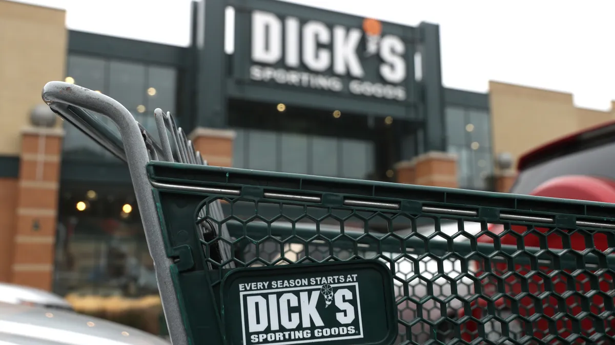 A shopping cart outside of a Dick's Sporting Goods store.